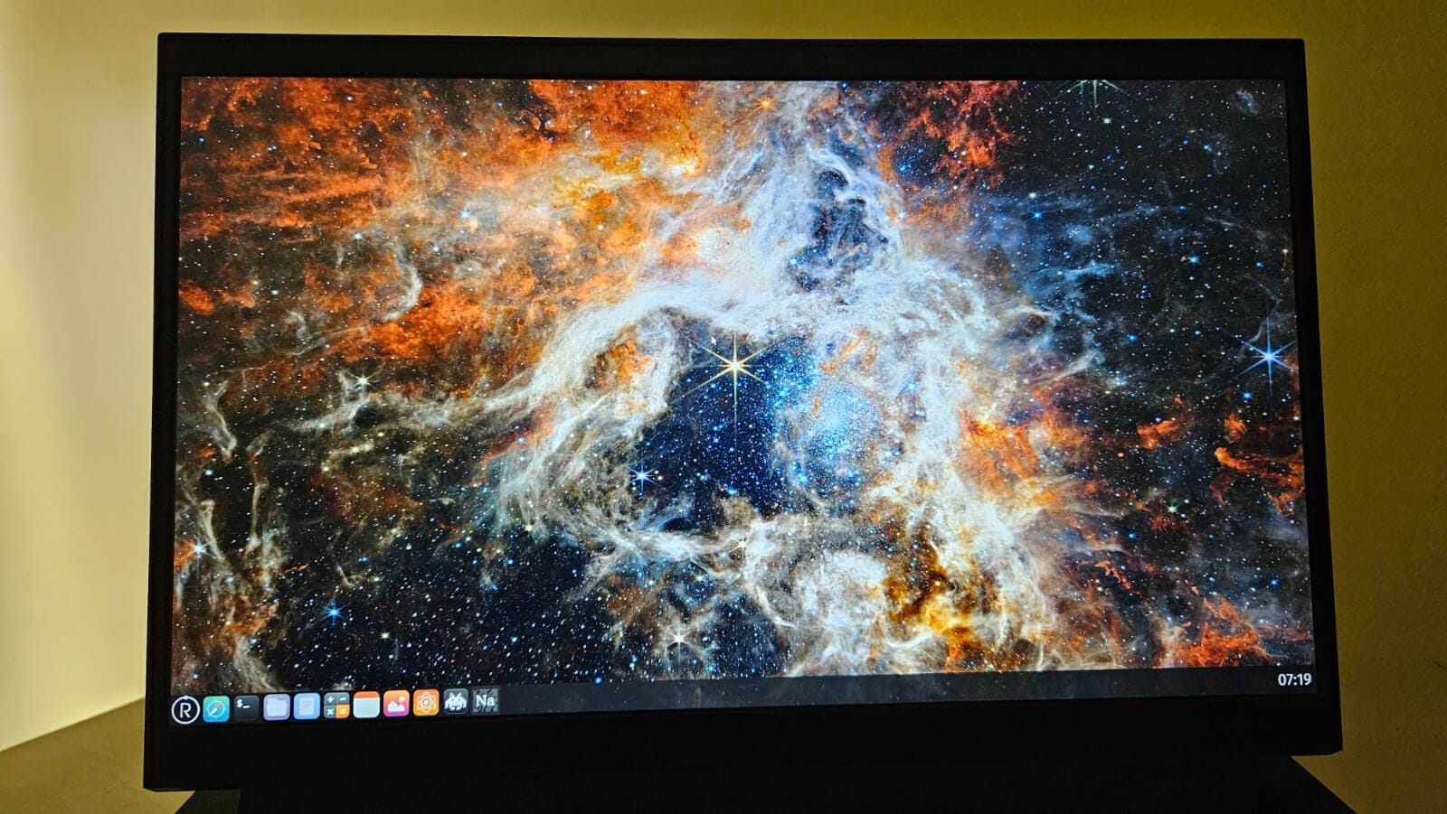 a screenshot of redox os running on a laptop with a wallpaper from nasa