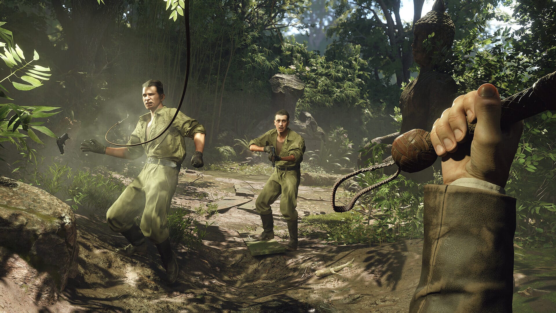 two armed enemies are shown getting beat with indiana's whip in a jungle