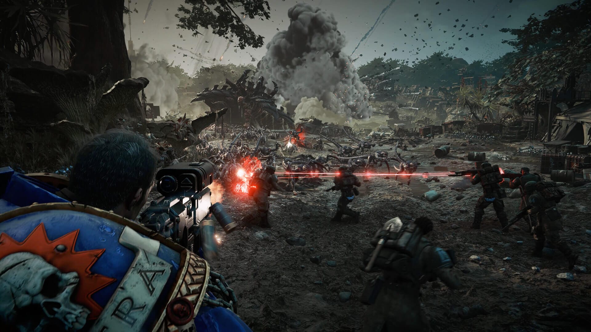 a space marine is seen shooting at enemies on a muddy battlefield with explosions in the background